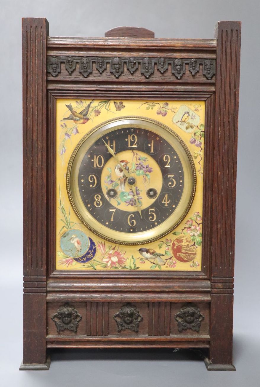 A French Aesthetic style oak mantel clock with enamelled ceramic dial, gong striking movement, 22cm wide